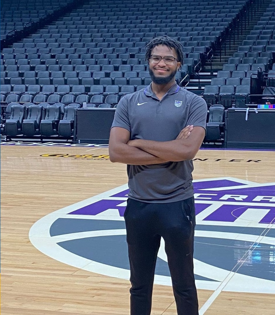 damarious borden standing with arms crossed on nba court