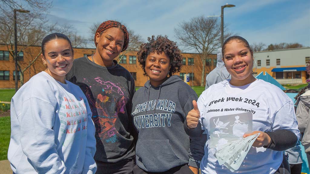 group of students standing outside of the wildcat center