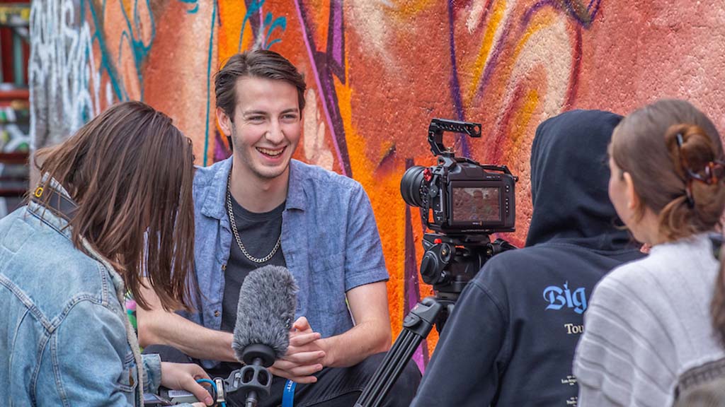 students filming together outdoors as a part of a DEE