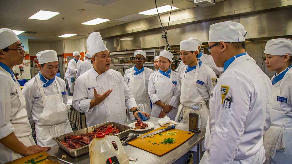 Culinary students gather in an international cuisine lab.