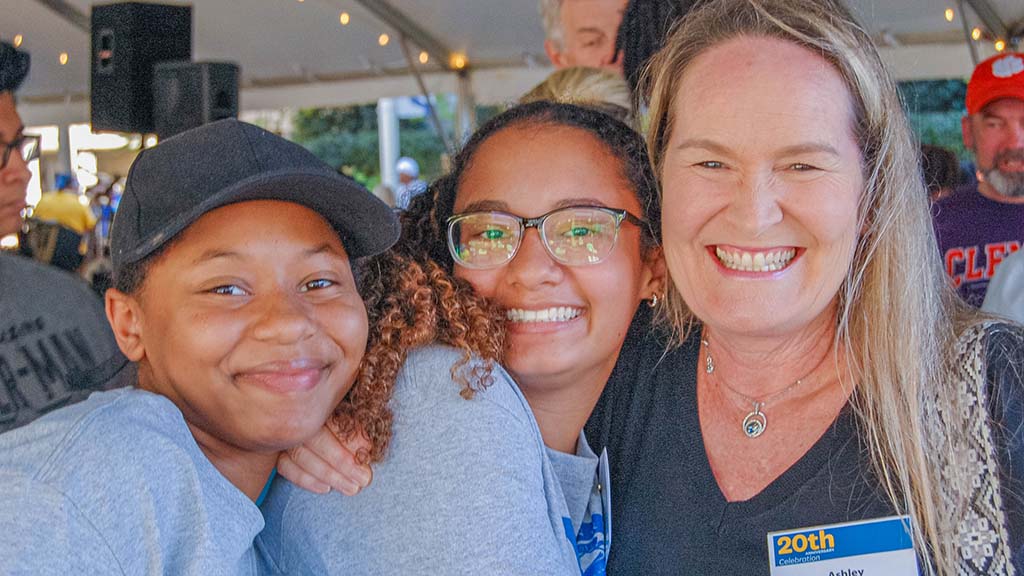 Professor Ashley McGee with two students at the celebration cookout.