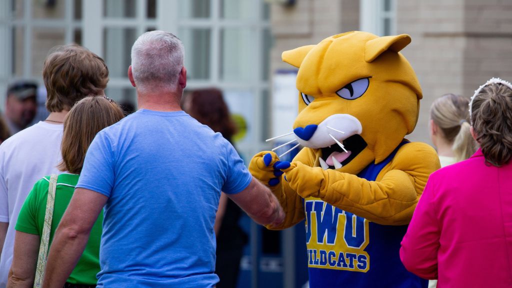 photo of JWU's mascot interacting with a group of parents