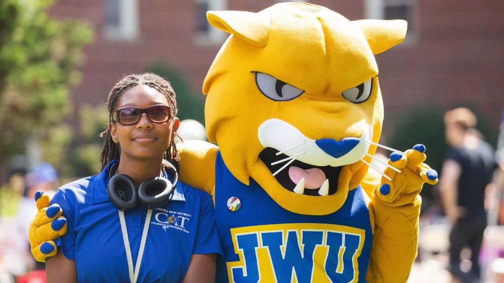 photo of Willie Wildcat and a JWU student