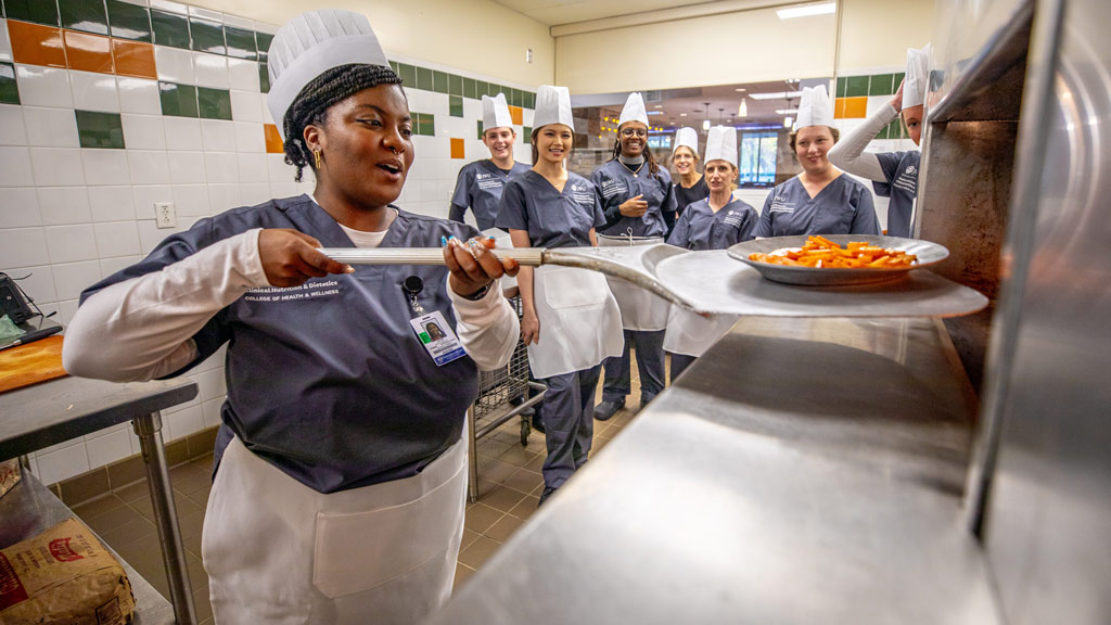 clinical nutrition students prepare food in one of JWU's kitchens