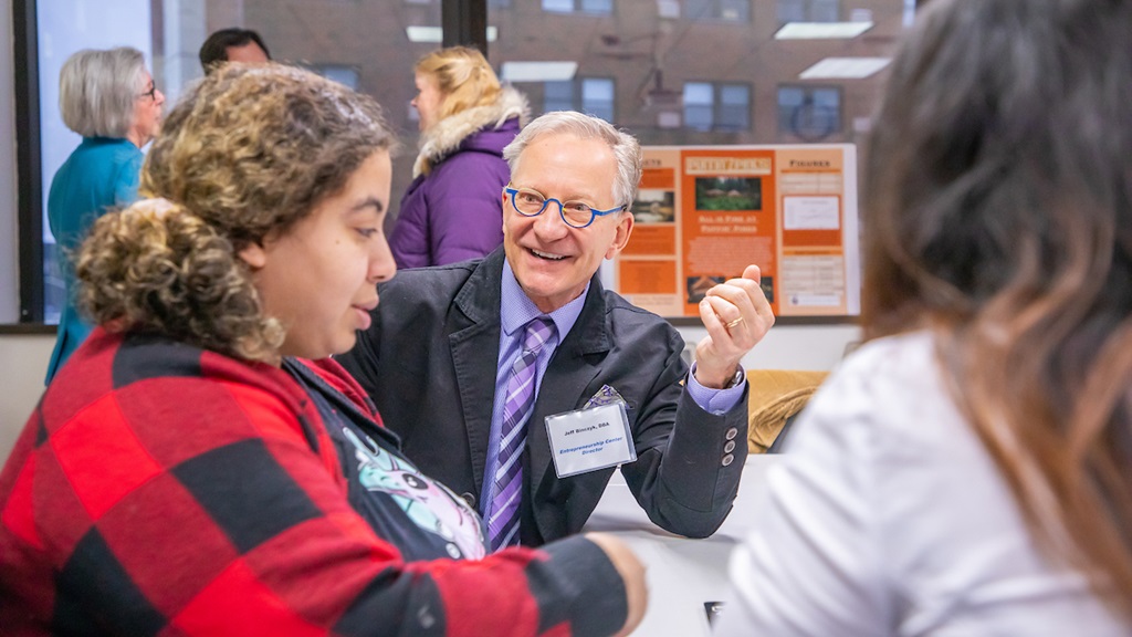 Professor speaking with student